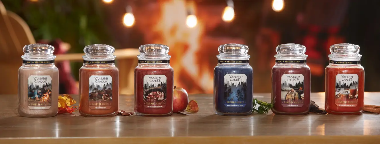 Elegant display of diverse Yankee Candle jars highlighting various scents and premium designs in a warm, inviting home setting